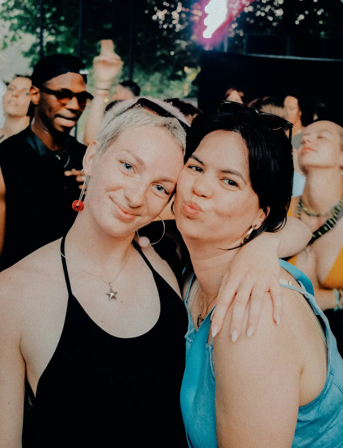 Friends smiling together at an outdoor gathering